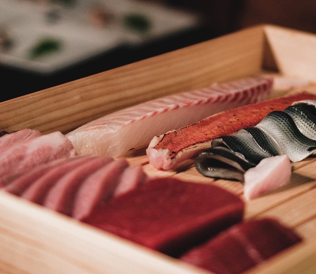 Sashimi served on a wooden board like in traditional Japanese sushi bars